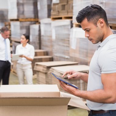 Portrait of male manager using digital tablet in warehouse